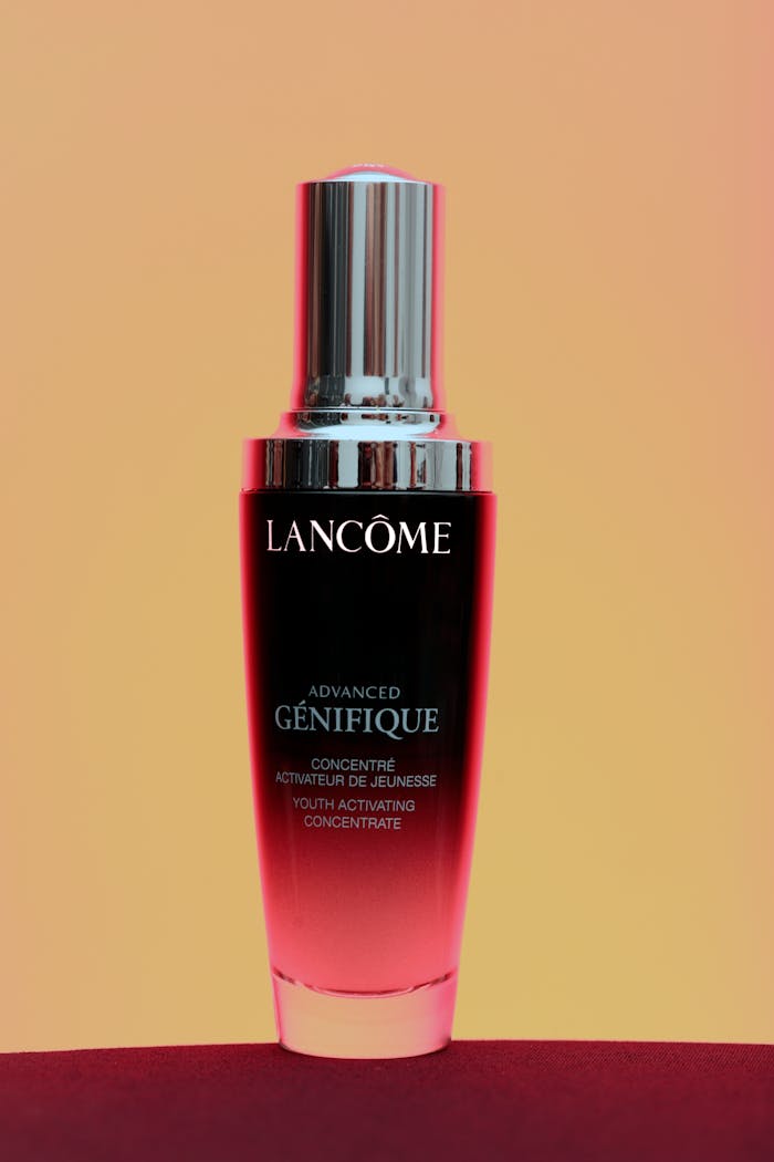 Lancôme Advanced Génifique serum bottle on a gradient background. Ideal for skincare and beauty themes.